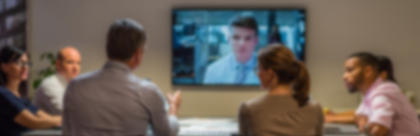 Blurred image of people in a meeting