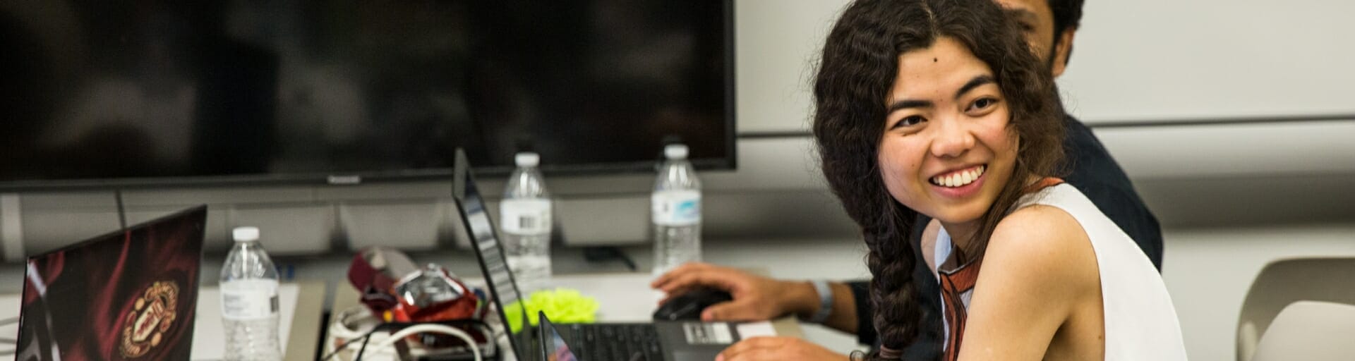 Person on a computer smiling