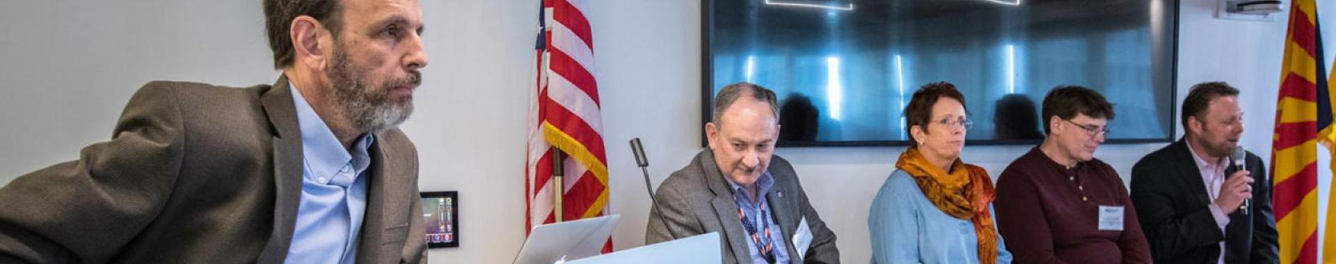 People sitting on a board panel